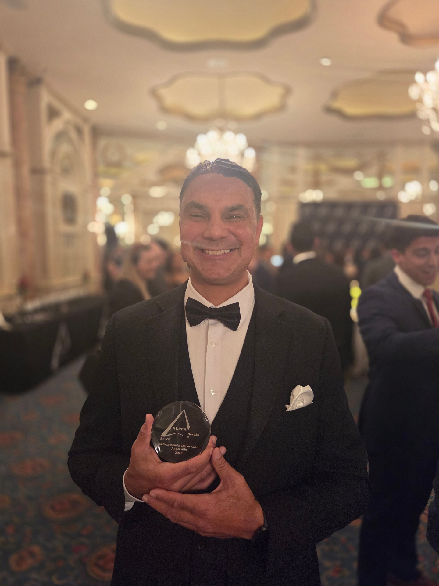 Angel Alba receiving the 2025 ALPFA Boston Next 50 Entrepreneurial Leader Award